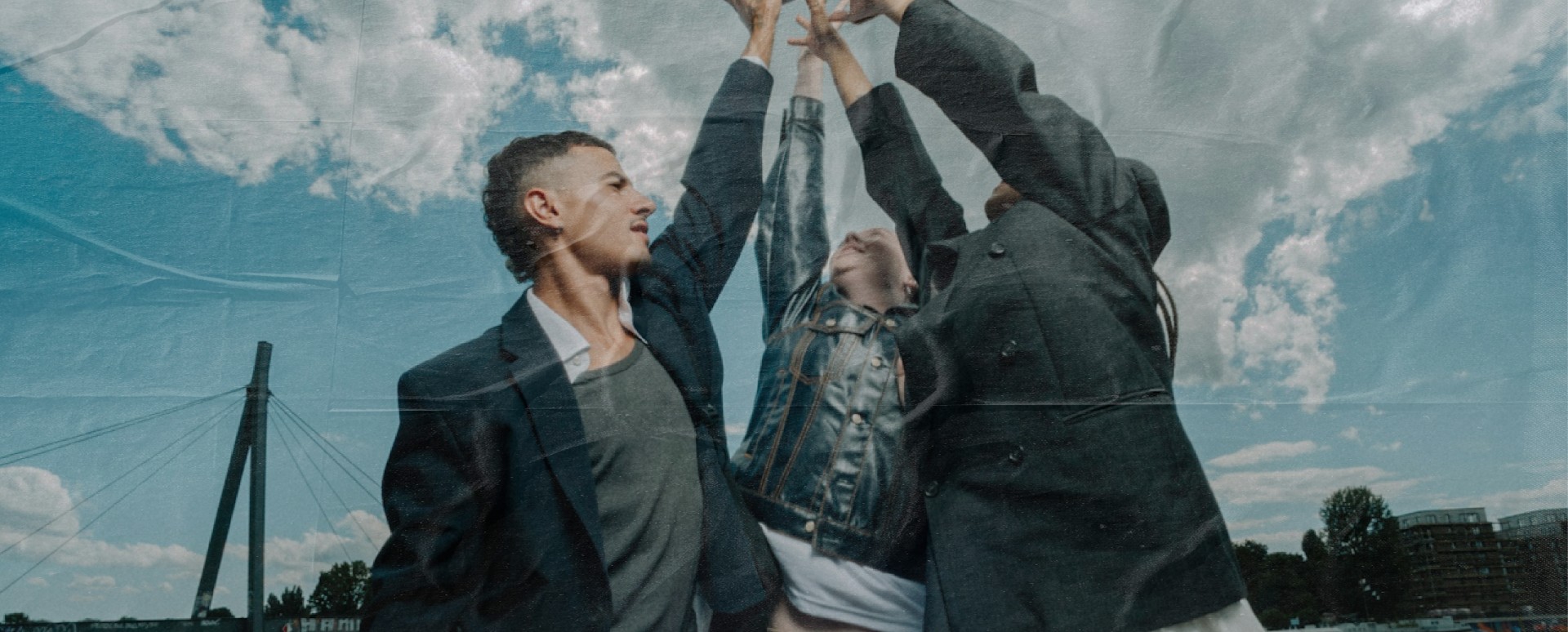 Three young adults doing an hi5